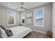 Bright bedroom with neutral colors, hardwood floors, and modern art at 6480 S Atlantic Ave, New Smyrna Beach, FL 32169