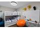 Fun bedroom featuring a bunk bed, whiteboard, storage drawers, and a bright orange beanbag chair at 6480 S Atlantic Ave, New Smyrna Beach, FL 32169