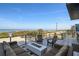 Outdoor deck features comfortable seating and stunning ocean views with a fire pit at 6480 S Atlantic Ave, New Smyrna Beach, FL 32169