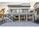 Modern two-story home featuring a beautiful outdoor kitchen, patio, and balcony, perfect for entertaining at 6480 S Atlantic Ave, New Smyrna Beach, FL 32169