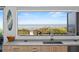 Well-lit modern kitchen featuring ocean views, countertops, and sleek cabinetry at 6480 S Atlantic Ave, New Smyrna Beach, FL 32169