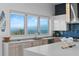 Bright, modern kitchen with stainless steel appliances, island, and ocean view at 6480 S Atlantic Ave, New Smyrna Beach, FL 32169