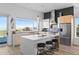 Modern open kitchen with an island, bar stools and ocean view at 6480 S Atlantic Ave, New Smyrna Beach, FL 32169