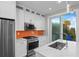 Bright kitchen with stainless appliances, stone countertops, and orange backsplash at 6480 S Atlantic Ave, New Smyrna Beach, FL 32169