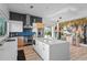 Modern kitchen with island, stainless steel appliances, wine storage, and stylish blue backsplash at 6480 S Atlantic Ave, New Smyrna Beach, FL 32169
