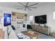 Bright living room features a comfortable sectional sofa, modern shelving, and stylish decor at 6480 S Atlantic Ave, New Smyrna Beach, FL 32169