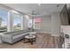 Spacious living room featuring a comfortable sofa, large windows, and stylish decor at 6480 S Atlantic Ave, New Smyrna Beach, FL 32169