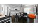 Open-concept living area connected to a modern kitchen, featuring comfortable seating and stylish decor at 6480 S Atlantic Ave, New Smyrna Beach, FL 32169