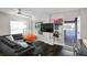 Comfortable living room with a modern sofa, stylish beanbag chair, mounted TV, and a bright window at 6480 S Atlantic Ave, New Smyrna Beach, FL 32169