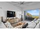 Bright living room with comfortable seating and an ocean view through large glass doors to the balcony at 6480 S Atlantic Ave, New Smyrna Beach, FL 32169