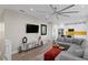 Open-concept living room with modern ceiling fan, hardwood floors, and view to adjacent kitchen at 6480 S Atlantic Ave, New Smyrna Beach, FL 32169