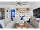 Bright and stylish living room showcasing modern decor, a large sectional sofa, and a custom wall unit at 6480 S Atlantic Ave, New Smyrna Beach, FL 32169