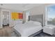 Comfortable bedroom with large bed, ensuite bathroom and large windows overlooking the area at 6480 S Atlantic Ave, New Smyrna Beach, FL 32169