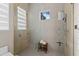 Modern tiled shower with glass enclosure, rain shower head, and a convenient bench at 6480 S Atlantic Ave, New Smyrna Beach, FL 32169