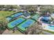 Aerial view of community tennis and basketball courts, and a playground, showcasing recreational amenities at 6735 Edgeworth Dr, Orlando, FL 32819