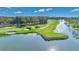 Beautiful aerial shot showcases a lush green golf course with a tranquil lake at 6735 Edgeworth Dr, Orlando, FL 32819