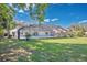 Large grassy backyard featuring a screened pool, perfect for outdoor living at 6735 Edgeworth Dr, Orlando, FL 32819