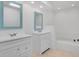 Bright bathroom with double sinks and tiled soaking tub at 6735 Edgeworth Dr, Orlando, FL 32819