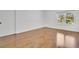 Large bedroom with hardwood floors and a window overlooking the yard at 6735 Edgeworth Dr, Orlando, FL 32819