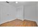 Bedroom with hardwood floors, ceiling fan, closet and an entrance door at 6735 Edgeworth Dr, Orlando, FL 32819