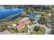 Aerial view of a community center featuring a pool, tennis courts, playground, and a lake at 6735 Edgeworth Dr, Orlando, FL 32819