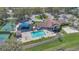 Aerial view of a community center featuring a pool, basketball court, playground, and tennis court at 6735 Edgeworth Dr, Orlando, FL 32819