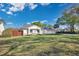 Charming single-story home with a well-maintained lawn and mature trees at 6735 Edgeworth Dr, Orlando, FL 32819