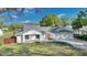 Charming single-story home featuring a well-manicured lawn, a three-car garage, and a cozy front entrance at 6735 Edgeworth Dr, Orlando, FL 32819