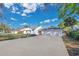 Attractive single-story home featuring a spacious driveway and a three-car garage at 6735 Edgeworth Dr, Orlando, FL 32819
