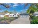 Charming one-story home with a well-manicured lawn, a two car garage, and a classic front door at 6735 Edgeworth Dr, Orlando, FL 32819