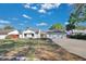 Charming one-story home with a well-manicured lawn, a two car garage, and a classic front door at 6735 Edgeworth Dr, Orlando, FL 32819