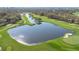 Beautiful aerial view of a lush golf course featuring a serene lake and manicured greens at 6735 Edgeworth Dr, Orlando, FL 32819