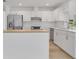 Bright kitchen featuring white cabinets, stainless steel appliances, and a light wood countertop at 6735 Edgeworth Dr, Orlando, FL 32819