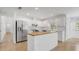 Modern kitchen featuring stainless steel appliances, white cabinets and a butcher block island top at 6735 Edgeworth Dr, Orlando, FL 32819