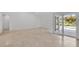 Bright living room with tile floors, neutral paint, baseboards, and slider glass doors leading to patio at 6735 Edgeworth Dr, Orlando, FL 32819