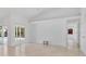 Spacious, bright living room with neutral paint, tile floors, slider glass doors, and natural sunlight at 6735 Edgeworth Dr, Orlando, FL 32819
