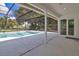 Covered patio area transitions seamlessly to the screened-in pool, enhancing outdoor living and entertaining at 6735 Edgeworth Dr, Orlando, FL 32819