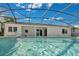 Backyard pool features a screened-in lanai, a relaxing retreat at 6735 Edgeworth Dr, Orlando, FL 32819