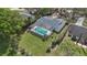 Aerial view of a home featuring a screened-in pool, a spacious yard, and mature landscaping at 6735 Edgeworth Dr, Orlando, FL 32819