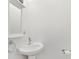 Bright white powder room with a classic pedestal sink at 6735 Edgeworth Dr, Orlando, FL 32819