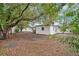 House backyard featuring a beautiful old tree canopy and lush greenery at 7121 Stockholm Way, Orlando, FL 32822