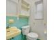 Retro bathroom features turquoise tile, sink, toilet, and storage at 7121 Stockholm Way, Orlando, FL 32822