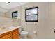 Cozy bathroom with tiled walls, wood vanity, sink, mirror, and window at 7121 Stockholm Way, Orlando, FL 32822