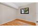 A bright bedroom featuring sleek wood floors and a window at 7121 Stockholm Way, Orlando, FL 32822