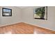 This bedroom has laminate wood floors and two windows with natural light at 7121 Stockholm Way, Orlando, FL 32822