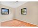 Light-filled bedroom with wood floors and dual window lighting at 7121 Stockholm Way, Orlando, FL 32822