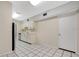 The kitchen features neutral cabinets, white appliances, tile floors and a door to another area at 7121 Stockholm Way, Orlando, FL 32822