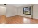 Bright living room featuring laminate wood flooring, a large window and neutral wall color at 7121 Stockholm Way, Orlando, FL 32822