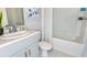 Bathroom features a single sink vanity, a shower/tub combo with white tile, and stylish decor at 7359 Capstone Dr, Groveland, FL 34736