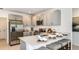 Stylish kitchen featuring stainless steel appliances, light gray cabinetry, and a breakfast bar with seating at 7359 Capstone Dr, Groveland, FL 34736